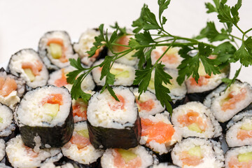 Rice rolls with smoked salmon and cucumber with fresh parsley for food presentations
