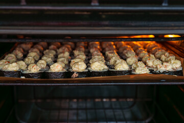 Baking California rolls with mayonnaise topping inside the oven for delicious homemade Japanese cuisine