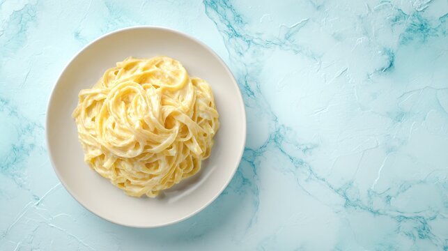 A flat lay of tagliolini with lemon cream sauce, pale blue marble surface, minimalist winter mood