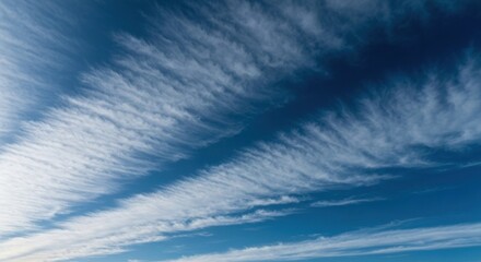 Wispy, feathery clouds streaked across a deep blue sky