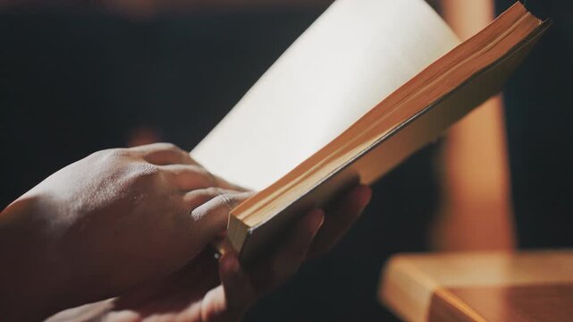 careful reading process, deliberate handling of aged papers, tenderly examining ancient manuscript pages under warm light, gently turning brittle pages of historic documents illuminated softly