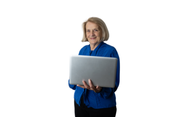 Senior woman smiling, holding silver laptop, connecting online
