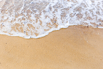 Sand beach with sea waves at coast. Copy space