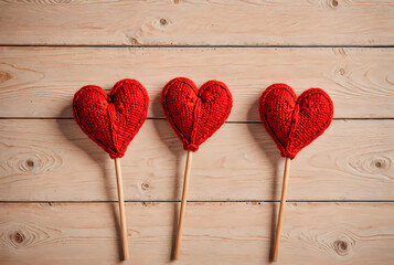 Three Red Heart Yarn Pins on Wood Surface for Valentine&rsquo;s Day, Love, and Friendship