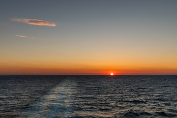 Golden sun setting over the Atlantic Ocean on the open sea