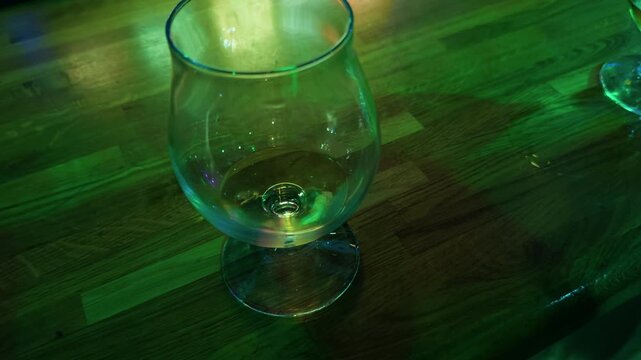 Nighttime bar solitude, Late evening ambiance featuring solitary drink and reflective lighting