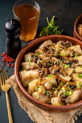 Stuffed cabbage rolls with mushrooms in rustic bowl vertical