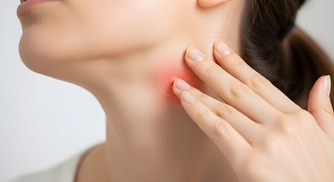 woman touching her neck