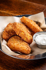 Crispy fried potato croquettes with dipping sauce vertical