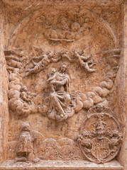 SALZBURG, AUSTIRA - SEPTEMBER 8 2025: The stone relief of Coronation of Madonna on exterior wall of the chapel Margarethenkapelle in the St. Peter Abtei cemetery by unknown artist.