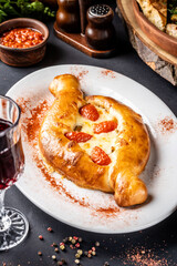 Warm baked khachapuri with melted cheese