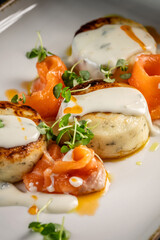 Creamy salmon with golden potato cakes
