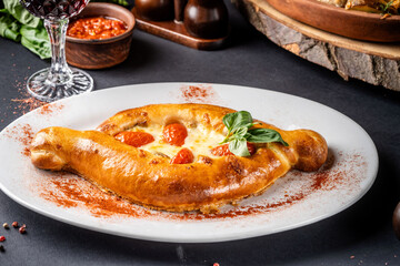 Golden baked khachapuri with fresh basil