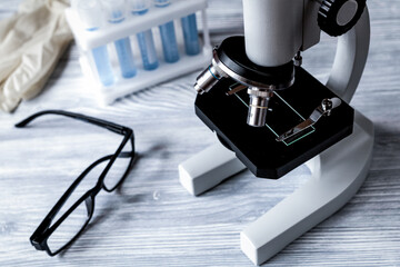 doctors desk with microscope and test tubes