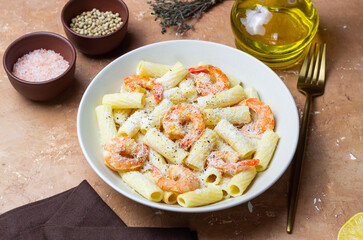 Pasta in a creamy sauce with shrimp and cheese. Seafood. Italian cuisine.
