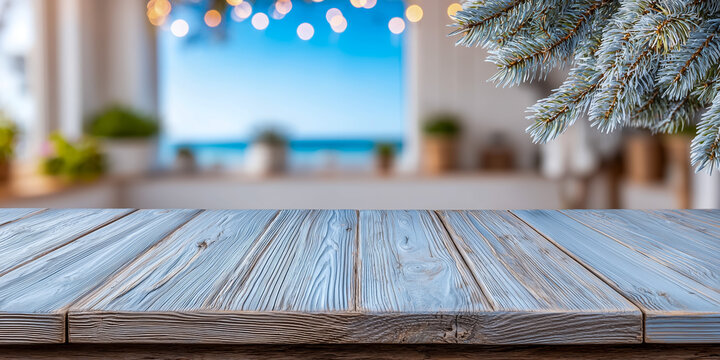 Wooden tabletop with festive pine branches and blurred background