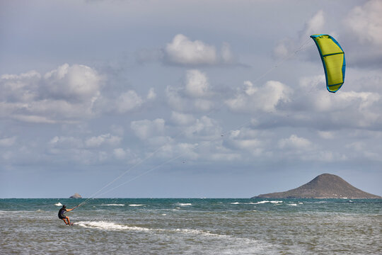 Mature man practicing kitesurfing. Aquatic sport. Athletic healthy senior