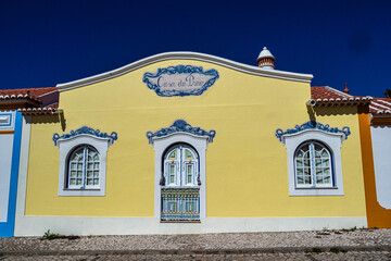 Obraz premium Traditional white houses with blue stripes in the streets of Ericeira in Portugal