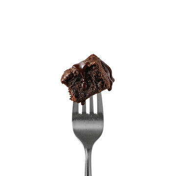 Decadent dark chocolate brownie square impaled on a silver fork against black backdrop