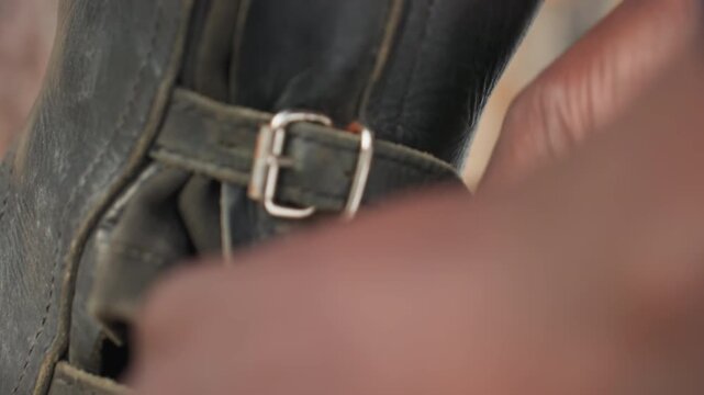 winter riding boot strap fastening, ensuring buckle on riding boots remains secure during winter riding, maintaining proper tension on riding boot strap and clasp for winter stability and safety