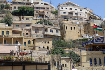 Old buildings and Jordanian flag at Salt city in west-central Jordan. It is an ancient trading city
