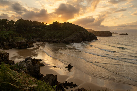 Beautiful sandy beach with rocky outcrops in the Eastern Coast of Asturias, Costa Verde, Spain