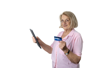 Senior woman shopping online using tablet and credit card