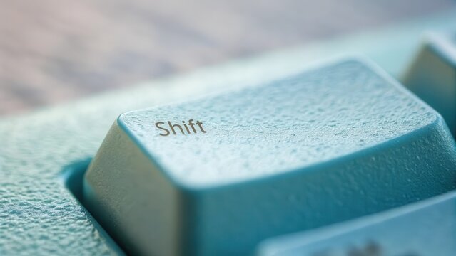 Macro closeup of a blue keyboard key labeled Shift - Powered by Adobe