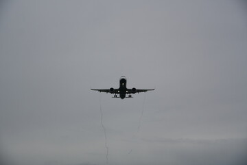 Commercial Airplane Approaching for Landing in Minimal Cloudy Sky
