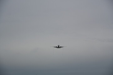 Passenger Airplane Approaching for Landing in Overcast Sky
