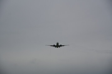 Passenger Airplane Approaching for Landing in Overcast Sky
