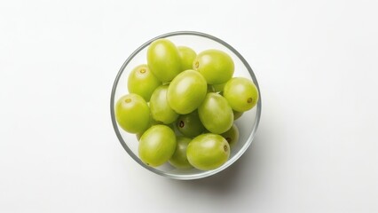 Fresh green grapes in a clear glass bowl on a white background