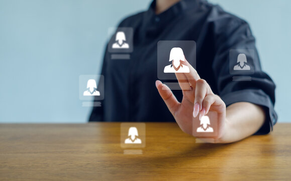 businesswoman interacting with virtual profile icons on a digital interface, symbolizing recruitment, HR management, and modern technology for selecting candidates and managing professional data.