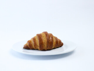 croissant on white plate isolated on white background