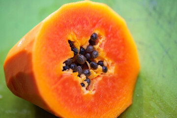 Orange red red heart papaya, close-up cross-sectional cut into sections
