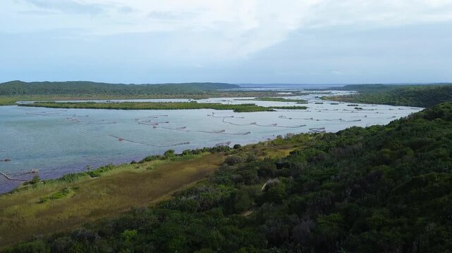 Kosi Bay Mouth with Traditional Thonga or Tsonga Fish traps, camera panning up along the river and lakes. 4K Aerial Video