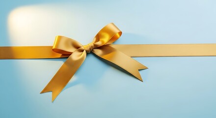 Fototapeta premium Elegant gold ribbon bow on light blue background for celebrations and gifting