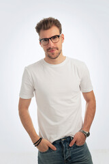 Young man smiling confidenty against isolated white background