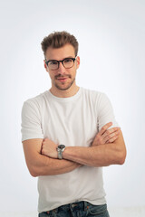 Young man smiling confidenty against isolated white background