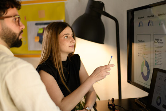 Business professionals discussing market strategy in a modern office during a team meeting focused on product analysis and competition - Powered by Adobe