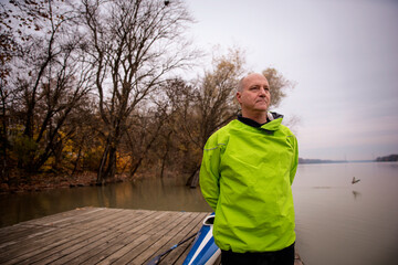 Confident senior man standing outdoor in an autumn day