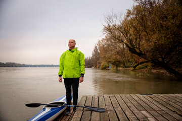 Confident senior man standing outdoor in an autumn day