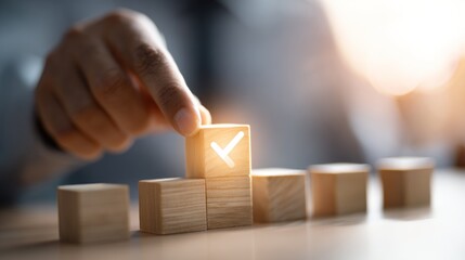 Hand placing check mark on wooden block