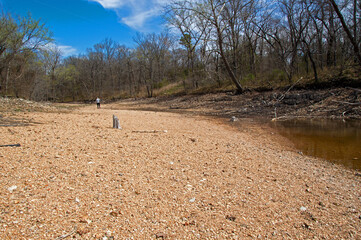 Shrunken lake leaves behind dry rock bed
