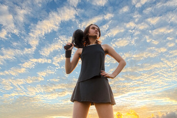 Padel junior tennis player with racket. Girl teenager athlete with paddle racket on court outdoors. Sport concept. Download a high quality photo for the design of a sports app or web site.