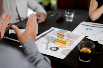 Fototapeta premium Business meeting focused on strategy development with colorful notes and charts on the table