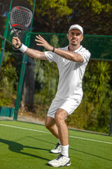 Padel player on the padel court with padel racket and ball in action. Open social tour template. Padel tennis player outdoors. Paddle tenis template for design ads with copy space.