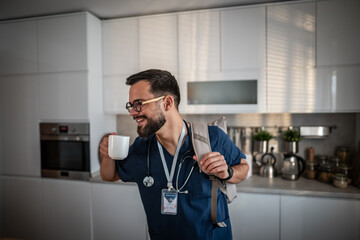 Male doctor drinking coffee, preparing for morning work commute