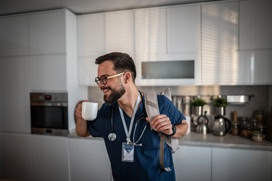 Male doctor drinking coffee, preparing for morning work commute