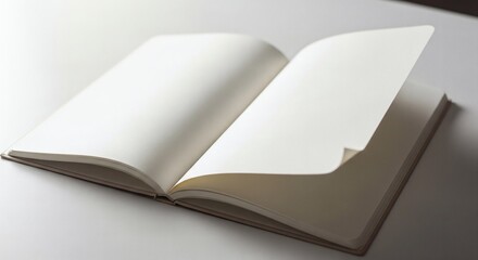 Open blank notebook revealing crisp, empty white pages on a desk.
